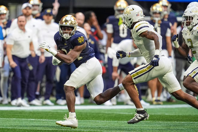 Oct 19, 2024; Atlanta, Georgia, USA; Notre Dame Fighting Irish running back Jadarian Price (24) runs against the Georgia Tech Yellow Jackets during the second half at Mercedes-Benz Stadium. Mandatory Credit: Dale Zanine-Imagn Images