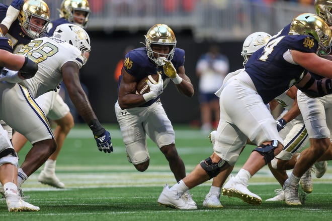 Oct 19, 2024; Atlanta, Georgia, USA; Notre Dame Fighting Irish running back Jadarian Price (24) runs the ball against the Georgia Tech Yellow Jackets in the fourth quarter at Mercedes-Benz Stadium. Mandatory Credit: Brett Davis-Imagn Images