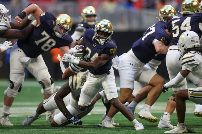 Oct 19, 2024; Atlanta, Georgia, USA; Notre Dame Fighting Irish running back Jadarian Price (24) runs the ball against the Georgia Tech Yellow Jackets in the fourth quarter at Mercedes-Benz Stadium. Mandatory Credit: Brett Davis-Imagn Images