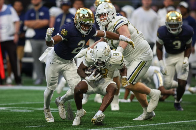 Oct 19, 2024; Atlanta, Georgia, USA; Notre Dame Fighting Irish safety Rod Heard II (2) tackles Georgia Tech Yellow Jackets wide receiver Malik Rutherford (8) in the fourth quarter at Mercedes-Benz Stadium. Mandatory Credit: Brett Davis-Imagn Images