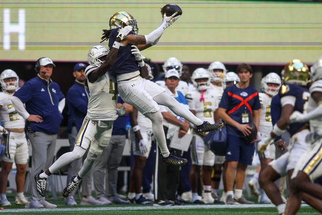 Oct 19, 2024; Atlanta, Georgia, USA; Notre Dame Fighting Irish safety Xavier Watts (0) intercepts a pass in front of Georgia Tech Yellow Jackets wide receiver Abdul Janneh Jr. (4) in the fourth quarter at Mercedes-Benz Stadium. Mandatory Credit: Brett Davis-Imagn Images