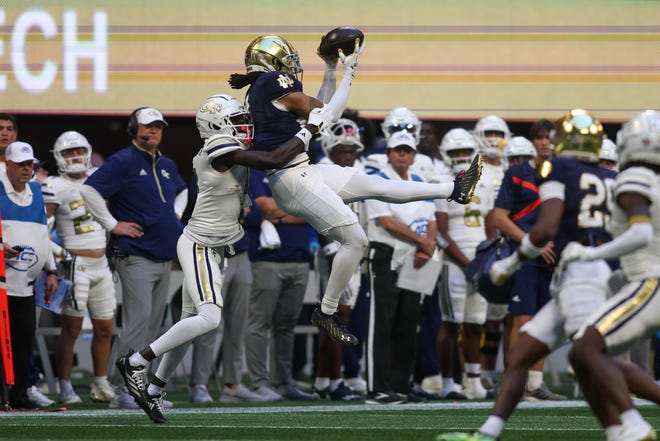 Oct 19, 2024; Atlanta, Georgia, USA; Notre Dame Fighting Irish safety Xavier Watts (0) intercepts a pass in front of Georgia Tech Yellow Jackets wide receiver Abdul Janneh Jr. (4) in the fourth quarter at Mercedes-Benz Stadium. Mandatory Credit: Brett Davis-Imagn Images