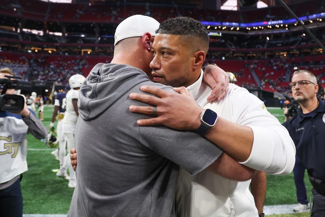 Oct 19, 2024; Atlanta, Georgia, USA; Notre Dame Fighting Irish head coach Marcus Freeman talks to Georgia Tech Yellow Jackets head coach Marcus Freeman after a game at Mercedes-Benz Stadium. Mandatory Credit: Brett Davis-Imagn Images