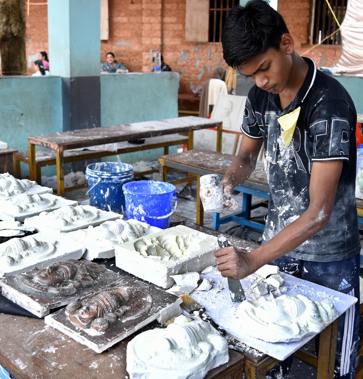 Anagh Dev, student of Government Higher Secondary School, Kozhikode Medical College campus, making an idol using plaster of paris at the Kozhikode district school science festival in Kunnamangalam on October 25.