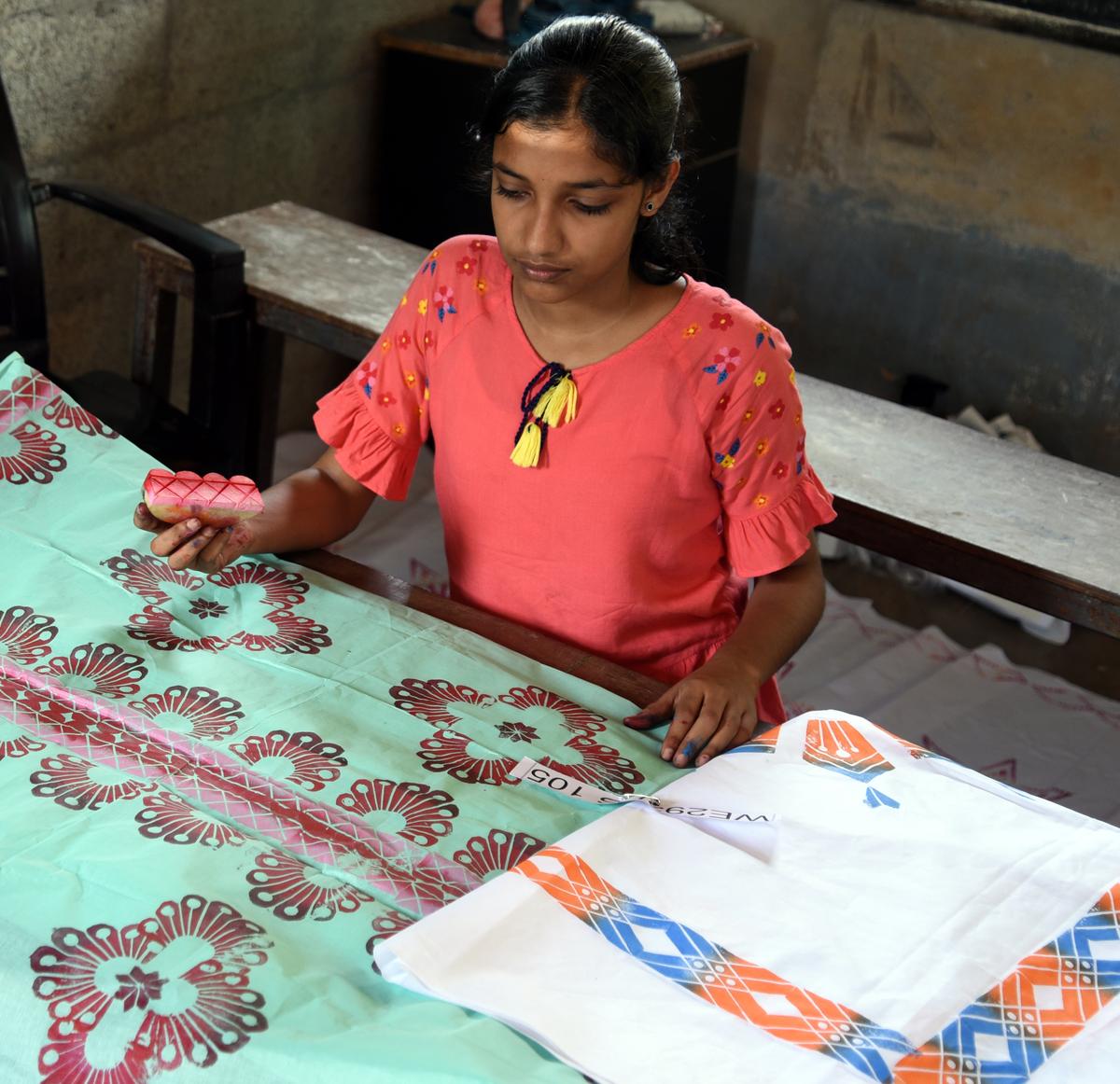 P. Gadha Krishna, student of Avala Kuttoth GHSS, engrossed in vegetable printing competition.