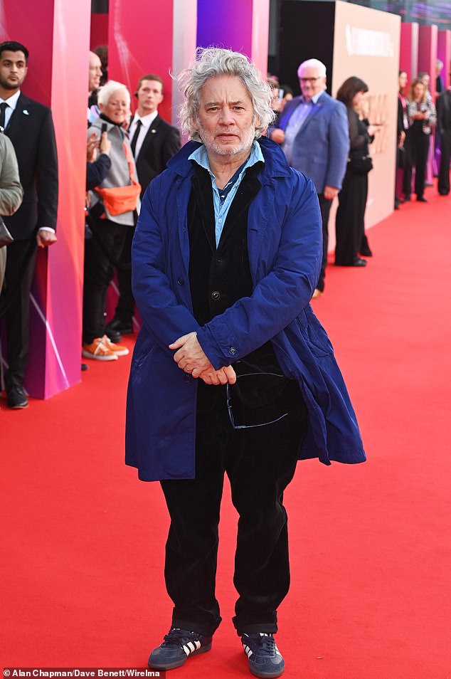 Actor and film director Dexter Fletcher braved the weather in a padded blue coat