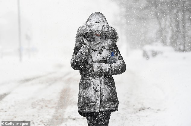 A woman makes her way through heavy snowfall in Scotland after freezing weather conditions and sub-zero temperatures caused chaos all of the UK in March 2018