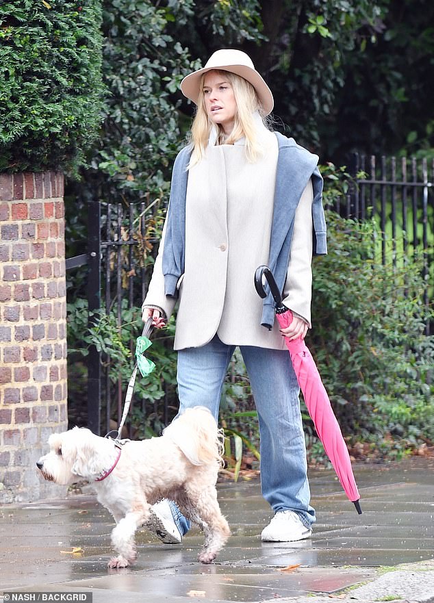 In case of a further downpour, Alice was seen holding her striking pink umbrella