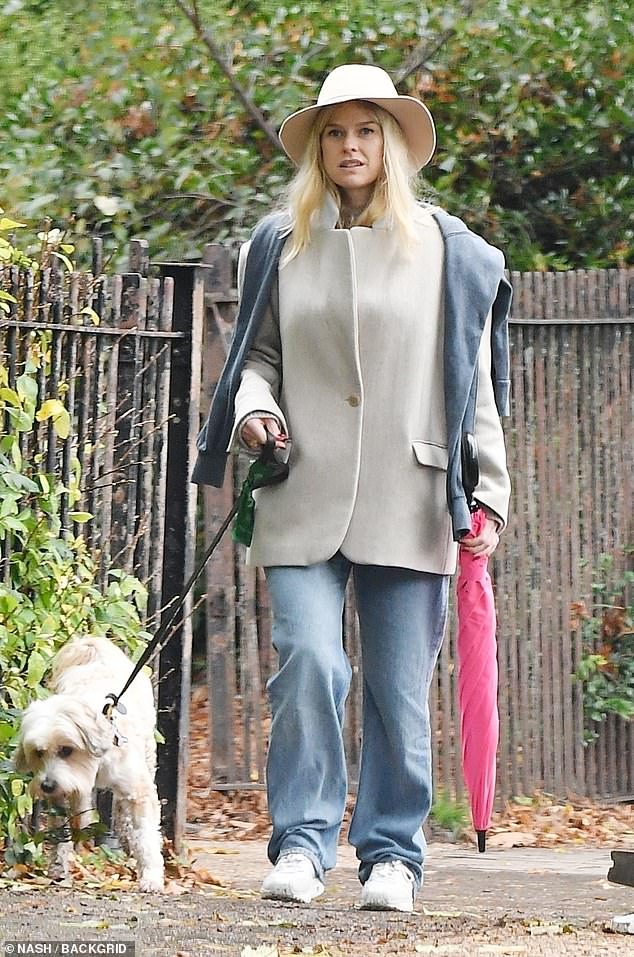 The star donned a cream coloured coat and matching coloured hat as she took her pooch on a walk