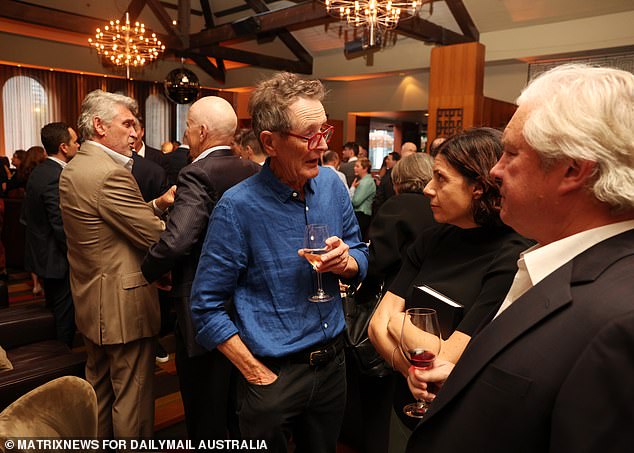 Paul Barry (pictured in blue shirt), the host of the ABC's Media Watch show, was also at the launch