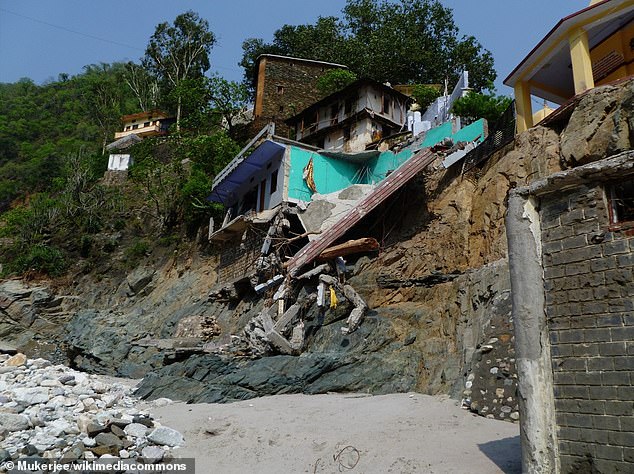 Flash floods and landslides from rain killed thousands in north India. Pictured, a broken end of footbridge over the Mandakini River at Rudraprayag Sangam