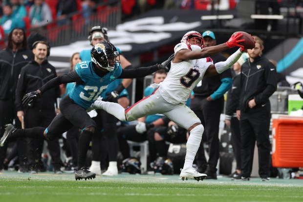 New England Patriots wide receiver Kayshon Boutte (9) makes a reception as Jacksonville Jaguars cornerback Montaric Brown (30) defends during the second half of an NFL football game, Sunday, Oct. 20, 2024, in London. (AP Photo/Ian Walton)