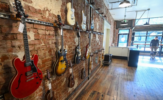 A variety of guitars sit on the wall at the Greeley Guitar Lounge located at 811 8th St. in Greeley on Oct. 25, 2024.(Jim Rydbom/Staff Photographer)