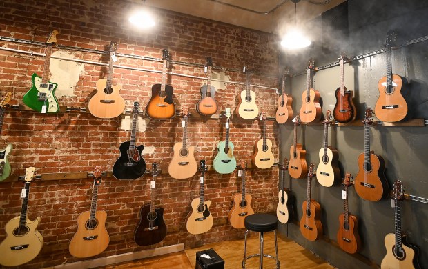 A variety of acoustic guitars sit on the wall at the new Greeley Guitar Lounge in Greeley at 811 8th St. on Friday Oct. 25, 2024.(Jim Rydbom/Staff Photographer)