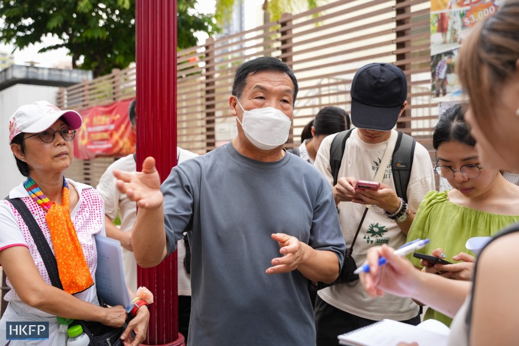 Leung King Fai (middle), a flower merchant who runs a business in the flower market since 1995, talks about his concern of the redevelopment scheme on October 18, 2024. Photo: Kyle Lam/HKFP. 