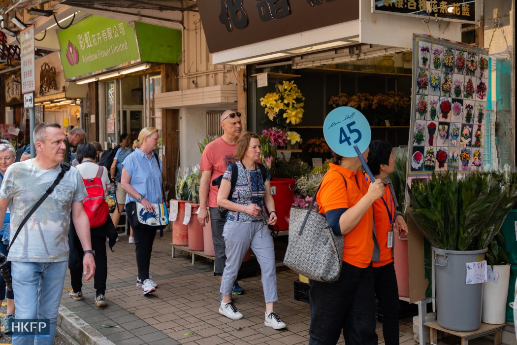 A group of tourists visit Flower Market, 11 April 2024. Photo: Kyle Lam/HKFP.