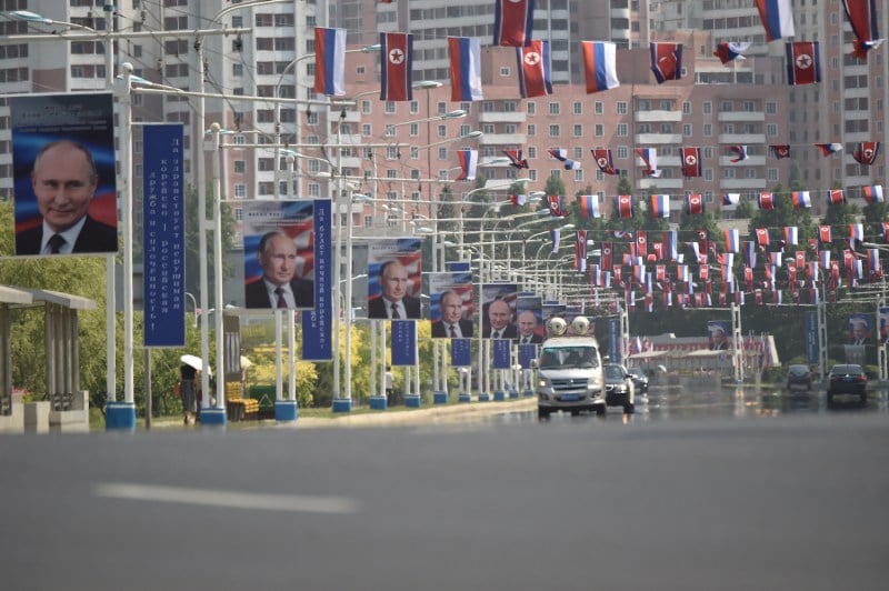 Images of Russian President Vladimir Putin are seen near national flags of North Korea and Russia in Pyongyang on June 20.