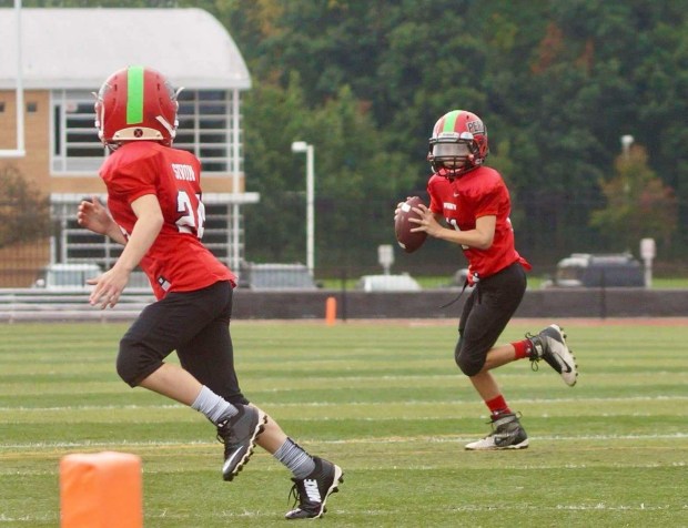 Young Walter Moses rolls out to throw a pass to Luke Sivon. Moses and Sivon are now seniors and Moses is the all-time leader in career passing yards and passing touchdowns at Perry. (Courtesy of Amy Moses)