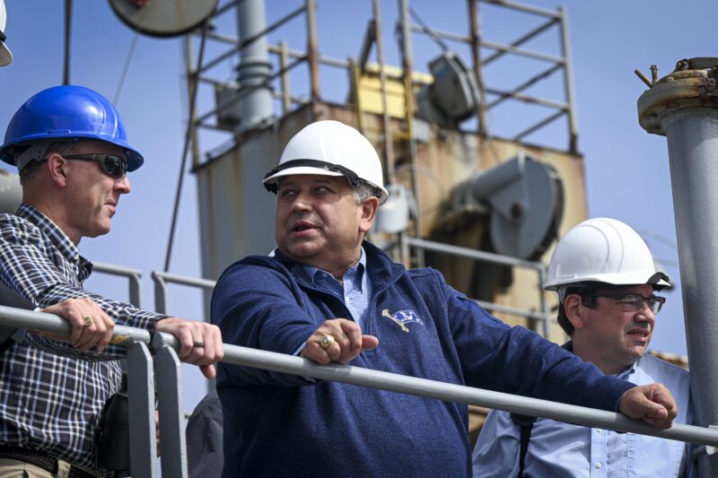 Secretary of the Navy Carlos Del Toro visits USNS Washington Chambers (T-AKE 11) during a demonstration of the Transferable Rearming Mechanism VLS Reloading At-Sea