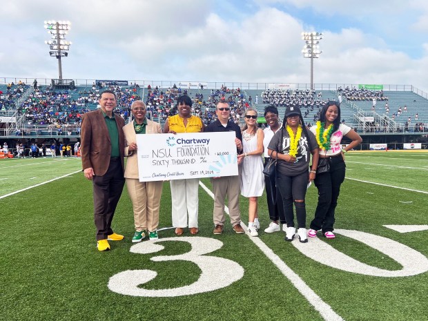 Chartway Credit Union leaders participated in the on-field presentation of a $60,000 check to the Norfolk State University Foundation to support university initiatives during the annual Battle of the Bay football game between Norfolk State and Hampton University on Sept. 14. Chartway introduced the cheering football fans to Promise Hero Chanel Garcia, a cancer survivor, who was recently granted her wish to go to Hawaii by the Chartway Promise Foundation. (Courtesy of Chartway)