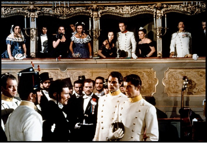 Army officers and aristocratic women in crinolines in a scene in La Fenice opera house in Visconti’s mid-19th-century-set ‘Senso’