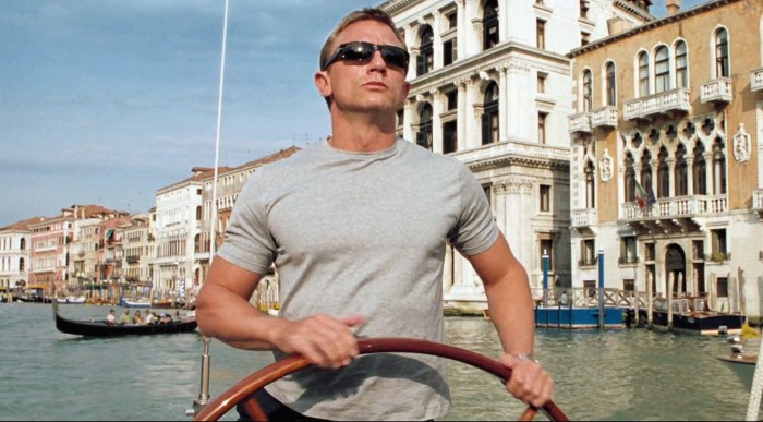 Daniel Craig wearing sunglasses and steering a boat on Venice’s Grand Canal in ‘Casino Royale’