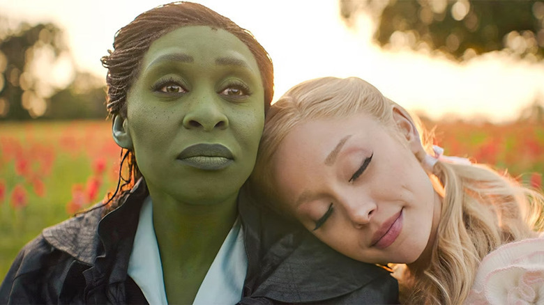 Ariana Grande rests her head on Cynthia Erivo's shoulder in Wicked