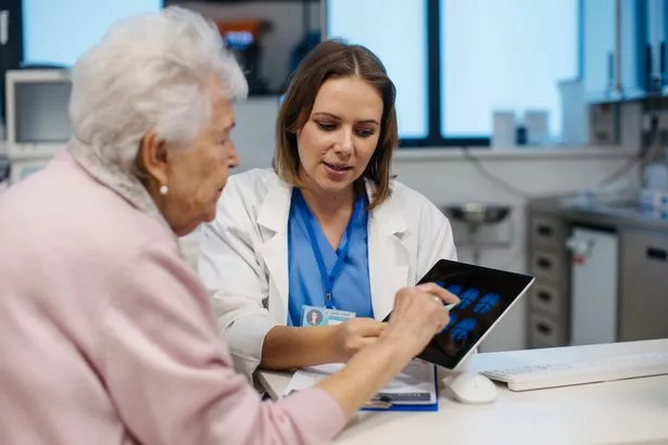 Doctor explaining results of MRI scan of brain to senior patient. Diagnosis of diseases for elderly people. Examination of brain, detecting stroke, dementia, head injures or neurological disorders.