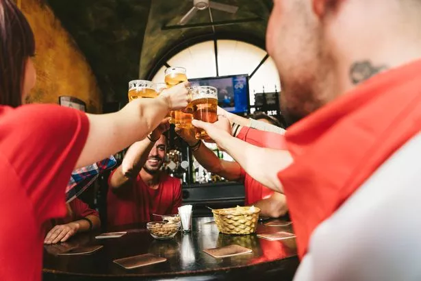 Group of happy friends drinking beer at the brewery