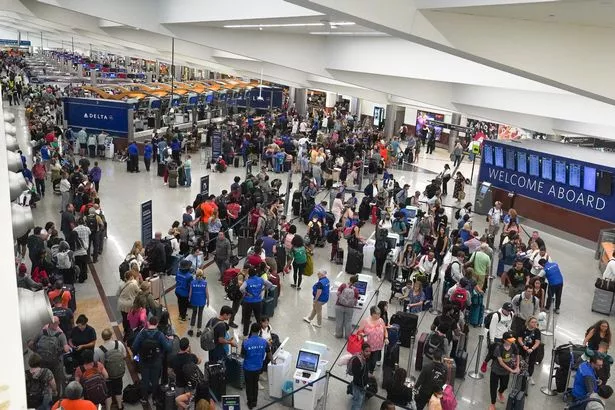 People wait in line at Hartsfield International Airport on July 20, 2024 in Atlanta, Georgia