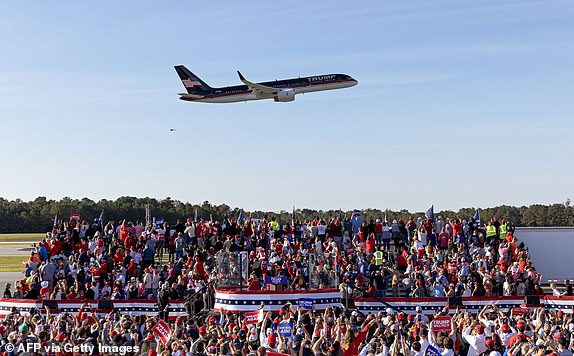 The plane carrying former US President Republican presidential candidate Donald Trump performs a fly-by before landing at a campaign rally in Kinston, North Carolina, on November 3, 2024. (Photo by Ryan M. Kelly / AFP) (Photo by RYAN M. KELLY/AFP via Getty Images)