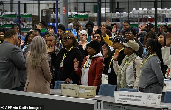 TOPSHOT - Philadelphia County board of elections staff are sworn-in before processing ballots at the ballot counting election warehouse on the outskirts of Philadelphia, Pennsylvania on November 5, 2024. (Photo by Ed JONES / AFP) (Photo by ED JONES/AFP via Getty Images)