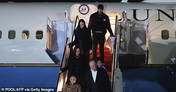 US Vice President and Democratic presidential candidate Kamala Harris steps off Air Force Two with family members (top to bottom) Nikolas Ajagu, Meena Harris, great-nieces Amara and Leela, and Second Gentleman Doug Emhoff, at Joint Base Andrews, Maryland, on November 5, 2024, after her final campaign stop in Philadelphia. (Photo by Jacquelyn Martin / POOL / AFP) (Photo by JACQUELYN MARTIN/POOL/AFP via Getty Images)