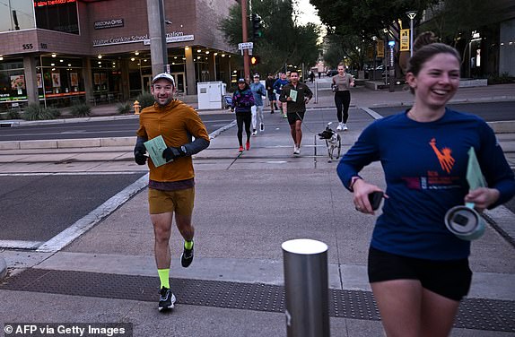 Members of a running group arrive at a polling station to drop off their ballots in Phoenix, Arizona, on Election Day, November 5, 2024. (Photo by Patrick T. Fallon / AFP) (Photo by PATRICK T. FALLON/AFP via Getty Images)