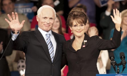 film still of man and woman waving in front of a crowd