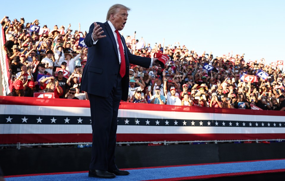 Donald Trump gestures to supporters as he walks onstage for a campaign rally on October 12 in Coachella, California