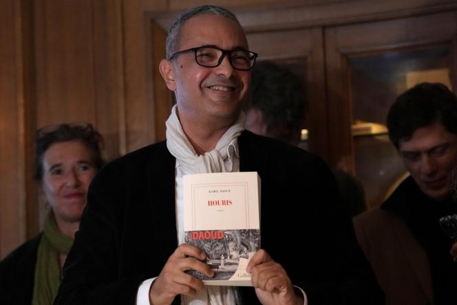 Algerian-French novelist Kamel Daoud holds his book Houris after being awarded with the Goncourt, France's most prestigious literary prize, Monday, November 4, 2024 in Paris.