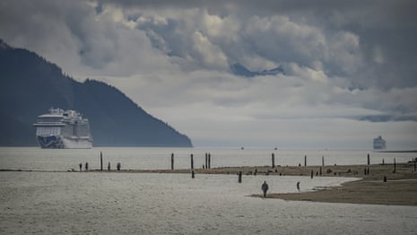 Cruise ships arrive in the Gastineau Channel as parkgoers walk their dogs at Savikko Park in Juneau, Alaska