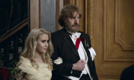 film still of man in white tie and a sash and a woman in a ballgown