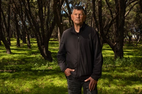 Richard Walley at the Burial Ground with trees and grasses behind him.