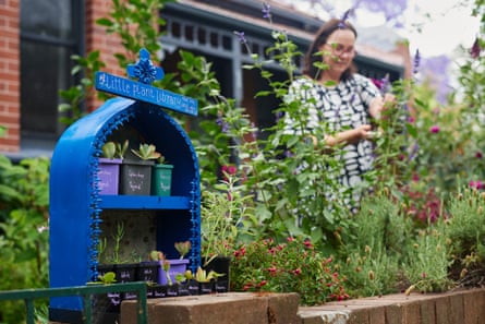 Sarah Davidson with the plant library she runs in her garden in Hurlstone Park, Sydney