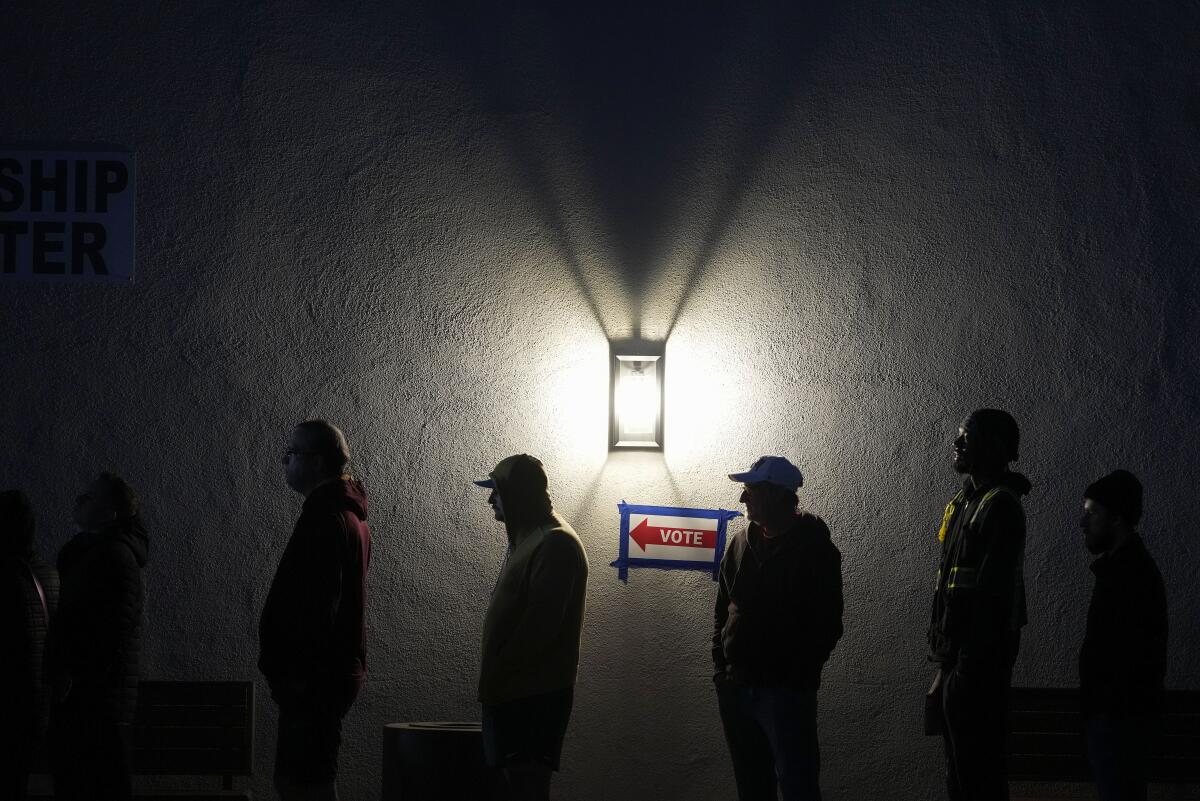 Voters stand in line outside a polling place 