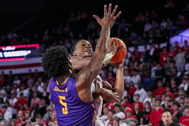 Nov 4, 2024; Athens, Georgia, USA; Georgia Bulldogs forward RJ Godfrey (10) looks rio shoot over Tennessee Tech Golden Eagles forward Rodney Johnson Jr. (5) during the first half at Stegeman Coliseum. Mandatory Credit: Dale Zanine-Imagn Images