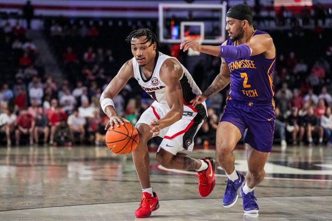 Nov 4, 2024; Athens, Georgia, USA; Georgia Bulldogs guard Tyrin Lawrence (7) dribbles against Tennessee Tech Golden Eagles guard Kyle Layton (2) during the first half at Stegeman Coliseum. Mandatory Credit: Dale Zanine-Imagn Images