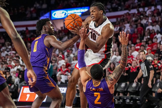 Nov 4, 2024; Athens, Georgia, USA; Georgia Bulldogs forward RJ Godfrey (10) collides with Tennessee Tech Golden Eagles guard Kyle Layton (2) on his way to the basket at Stegeman Coliseum. Mandatory Credit: Dale Zanine-Imagn Images