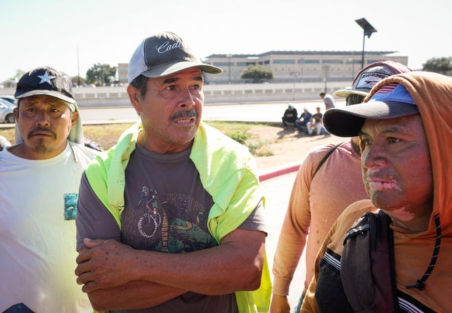 Undocumented immigrants, left to right, Hermelindo Mendoza, of Guatemala, Victor Rodriguez, of Mexico, and Juan Gomez Vasquez, of Guatemala, wait for day labor jobs at a Home Depot in South Austin Wednesday November 6, 2024.