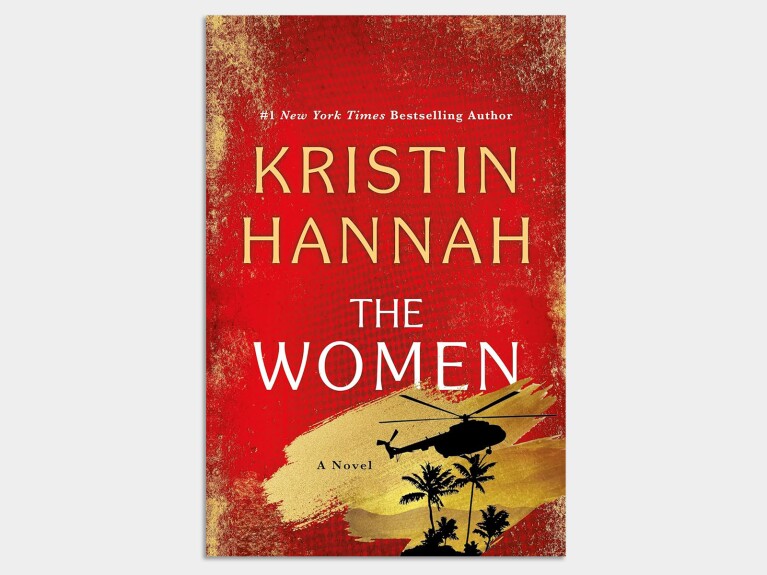 Book cover: The Women by Kristin Hannah, featuring a red background with gold text and helicopter silhouette