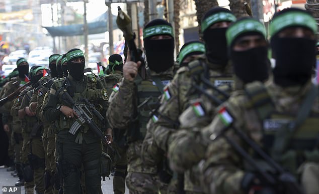 Hamas said the United States election was a matter for the American people but it called for an end to the 'blind support' for Israel from the US. Pictured are Hamas terrorists from the Izzedine al-Qassam Brigades marching with their rifles a long the streets of Nusseirat refugee camp in Gaza in May 2021