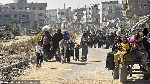 Palestinians flee towards Gaza from Beit Lahia on Wednesday, carrying the belongings they could take with them, as the Israeli army continues to force their displacement