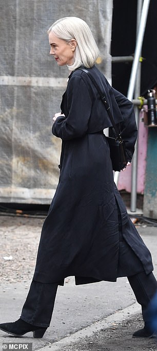 She also sported a black cross-body bag and further elevated her height with black heeled boots